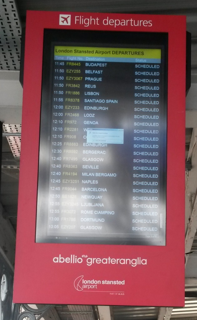 [Stansted Airport]A screen at Cambridge station (between platforms 2 and 3) shows flights leaving Stansted Airport around 90 or more minutes from now. Unfortunately there is a windows popup error in the middle of the screen. There is another of these screens on platforms 7/8, where many Cross Country trains depart for Stansted Airport