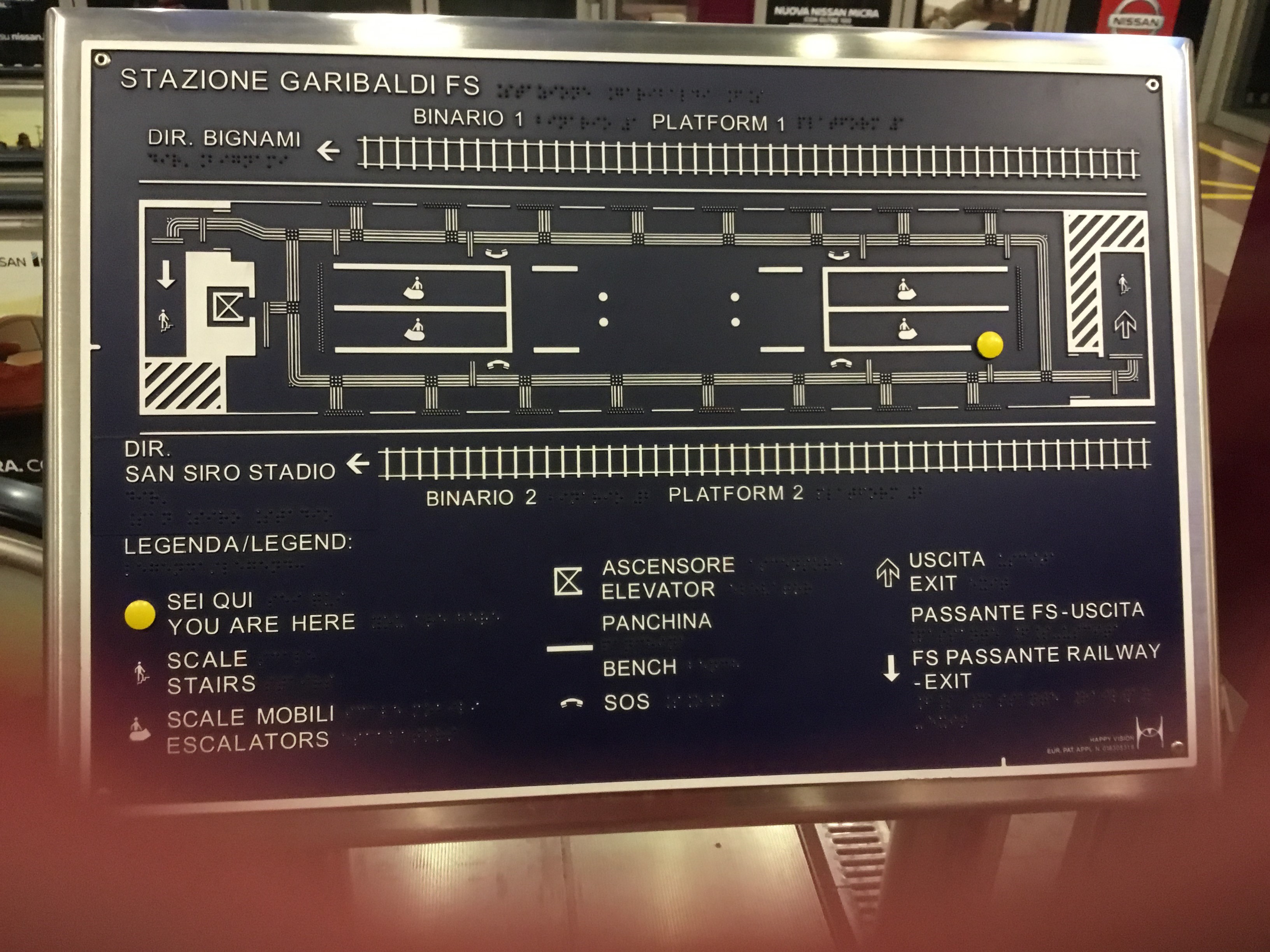 [Milan]Platform Braille way-finding sign (also raised text in Italian and English) in Milan.   Photo by Ian Brown for Railfuture.