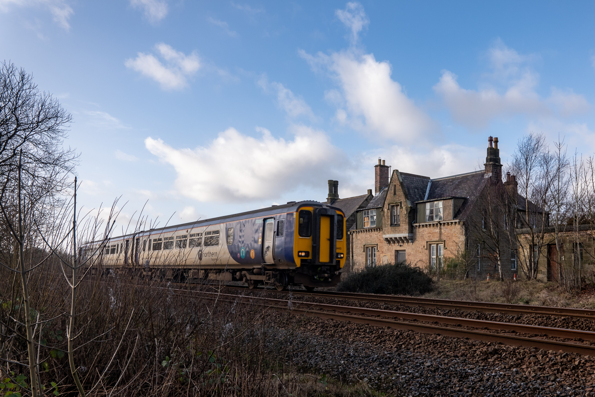 Class 156 passes Gilsland Station